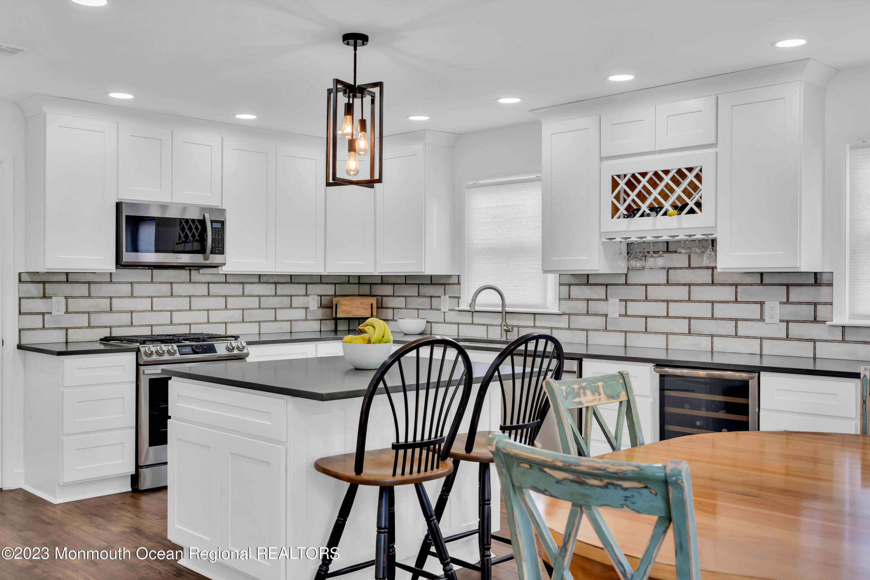 11 Garrett Road Toms River, NJ 08757 - Photo 29 of 61 a kitchen with stainless steel appliances granite countertop a stove top oven a sink a dining table and chairs