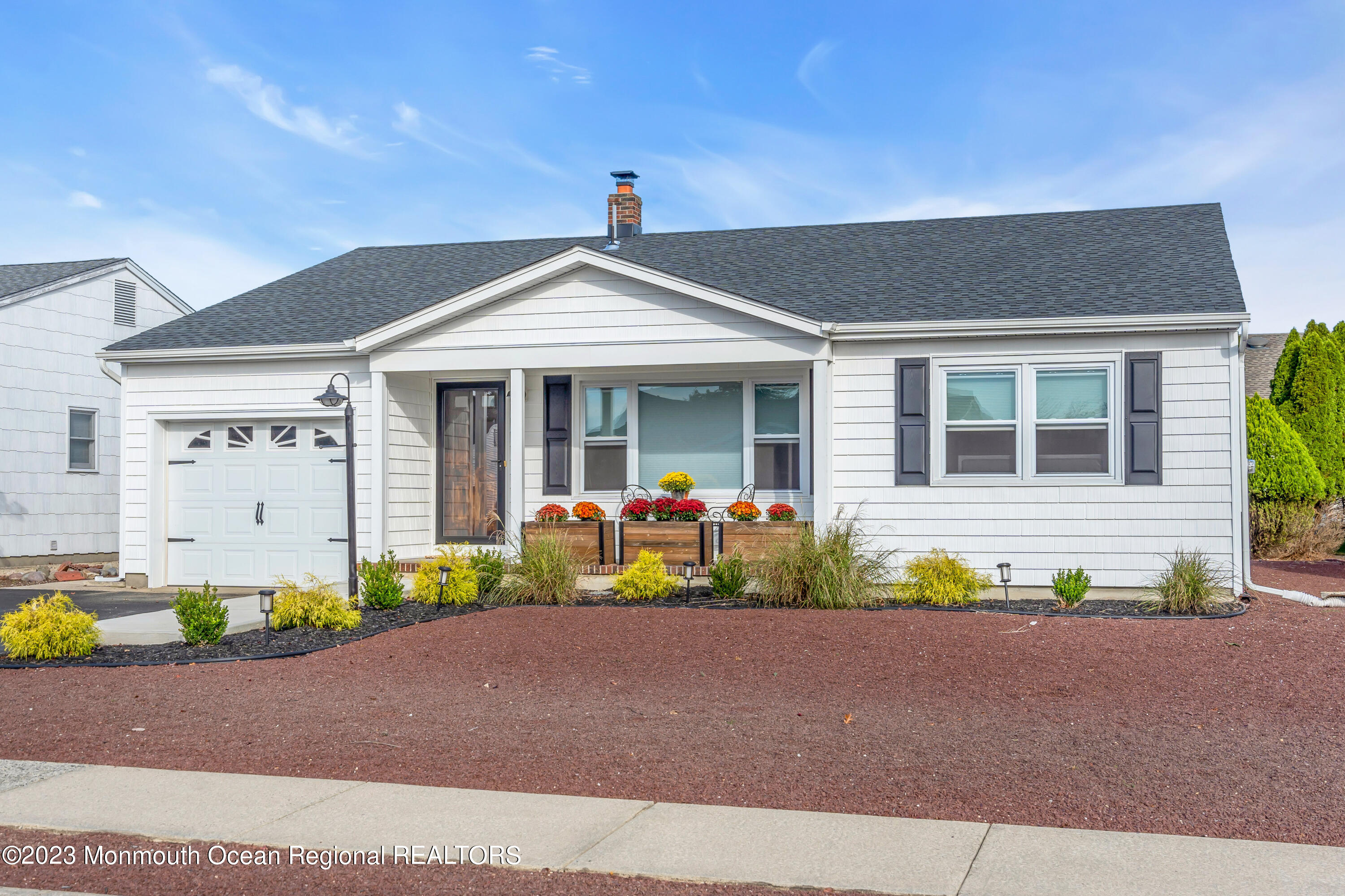 11 Garrett Road Toms River, NJ 08757 - Photo 3 of 61 a front view of a house with a yard and a garage