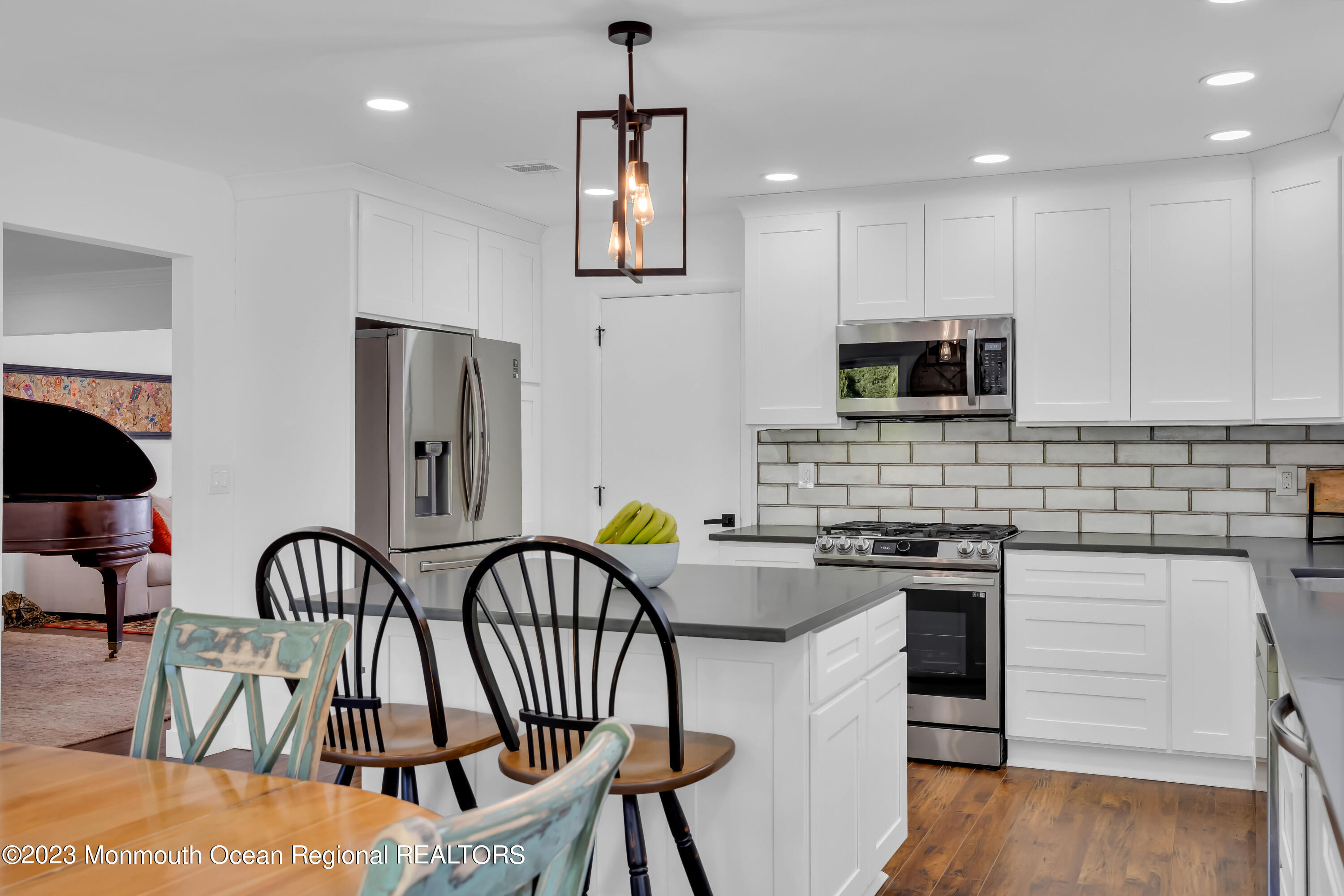 11 Garrett Road Toms River, NJ 08757 - Photo 31 of 61 a kitchen with stainless steel appliances granite countertop a stove top oven a sink a dining table and chairs