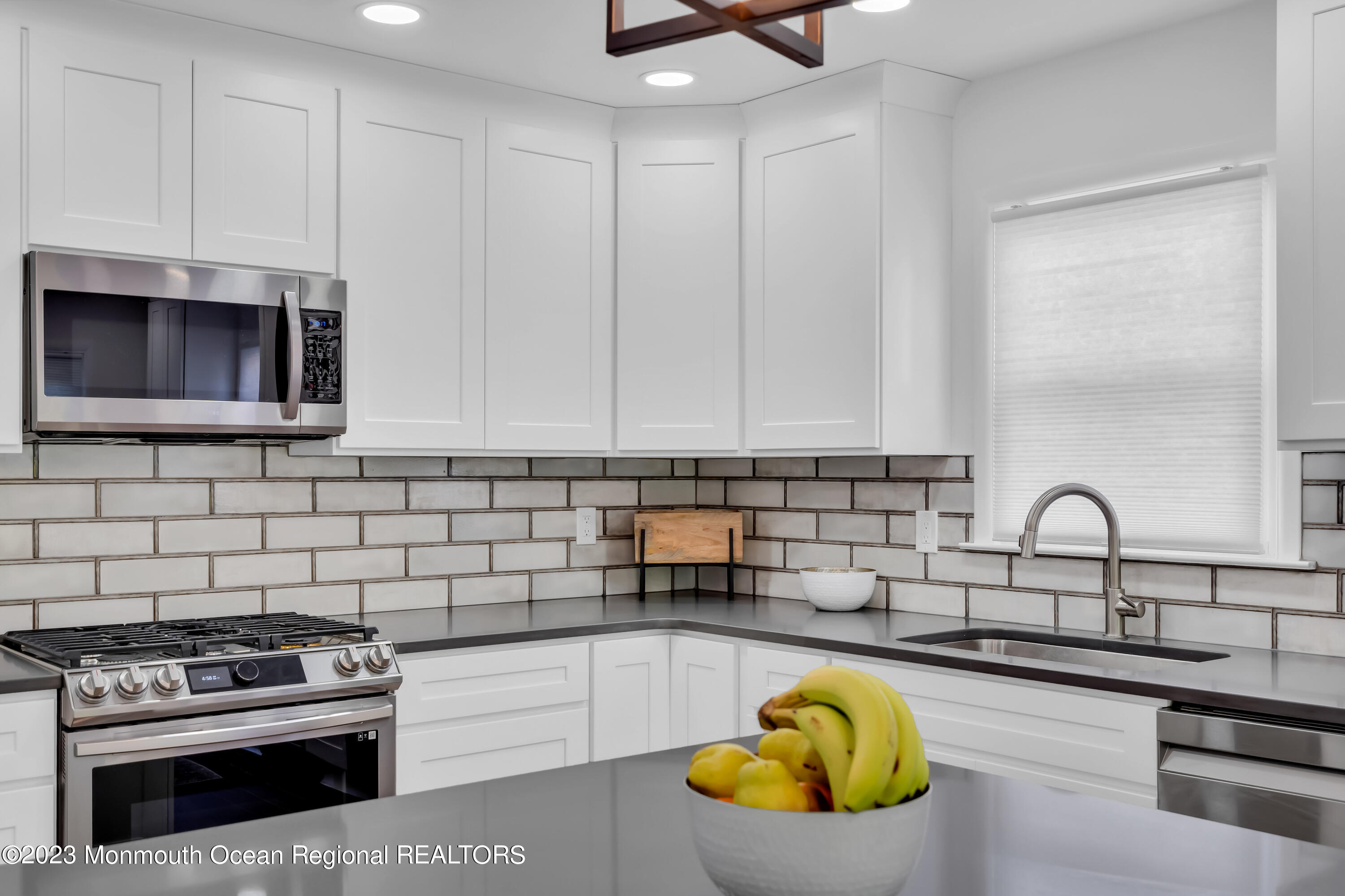 11 Garrett Road Toms River, NJ 08757 - Photo 33 of 61 a kitchen with a stove a sink and a microwave