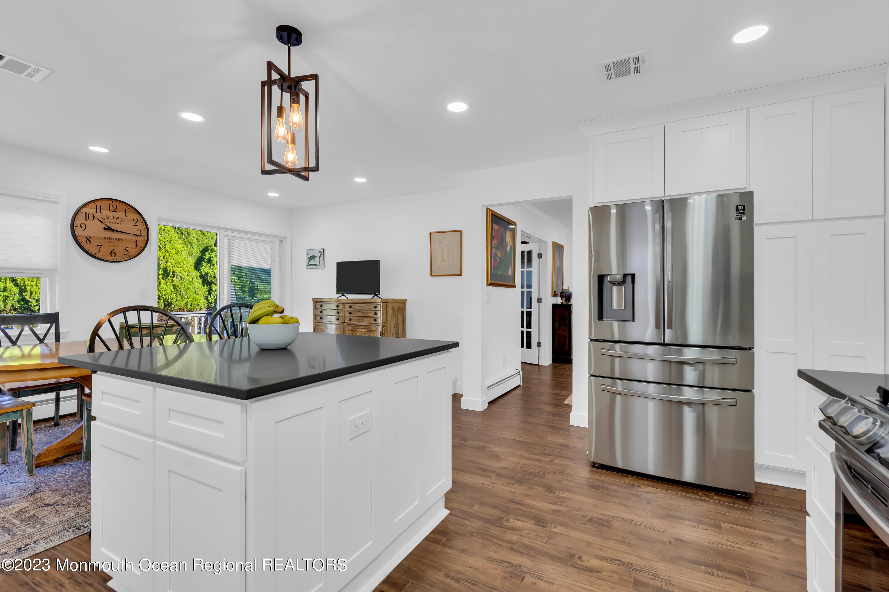 11 Garrett Road Toms River, NJ 08757 - Photo 36 of 61 a kitchen with granite countertop a refrigerator a stove a sink and a dining table with wooden floor