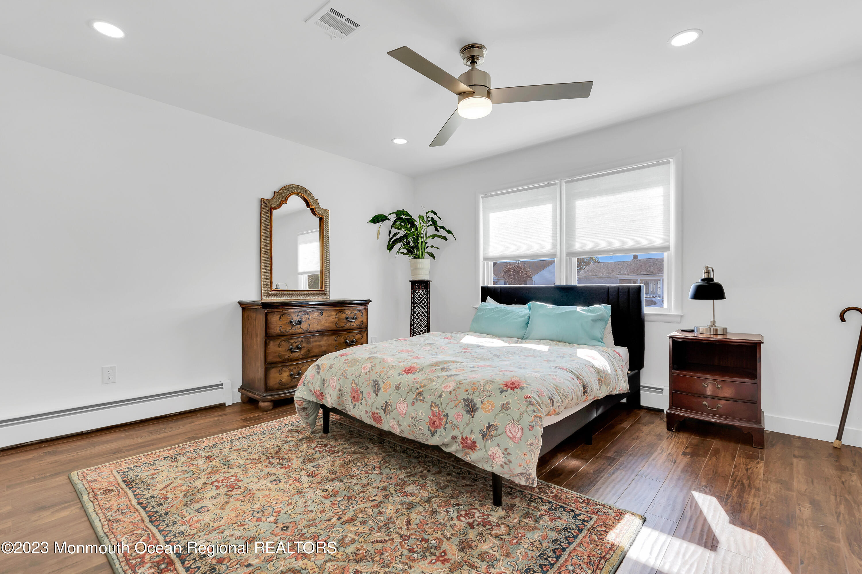 11 Garrett Road Toms River, NJ 08757 - Photo 47 of 61 a bedroom with a bed a dresser and potted plants with wooden floor