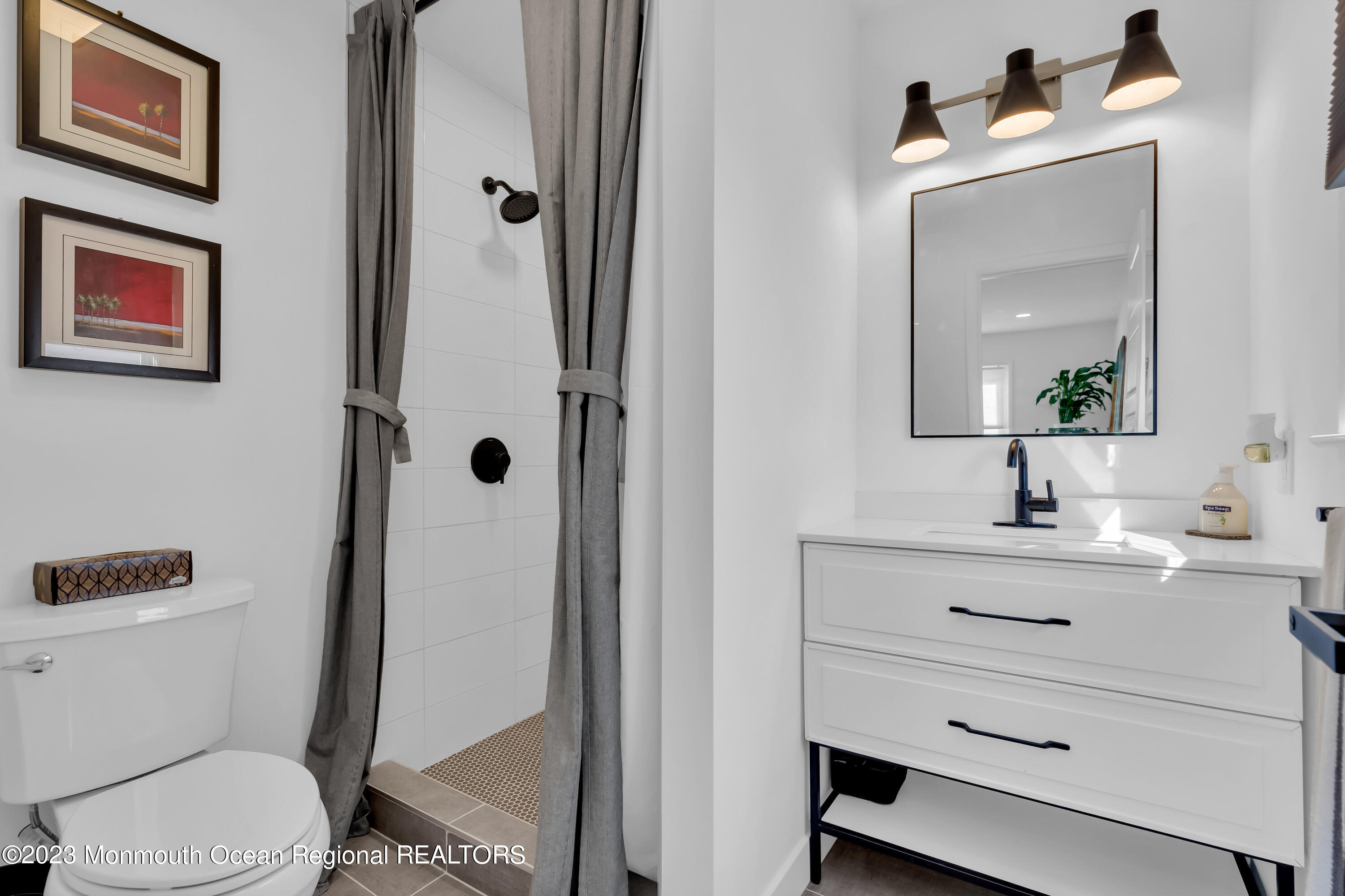 11 Garrett Road Toms River, NJ 08757 - Photo 49 of 61 a bathroom with a toilet sink vanity and mirror