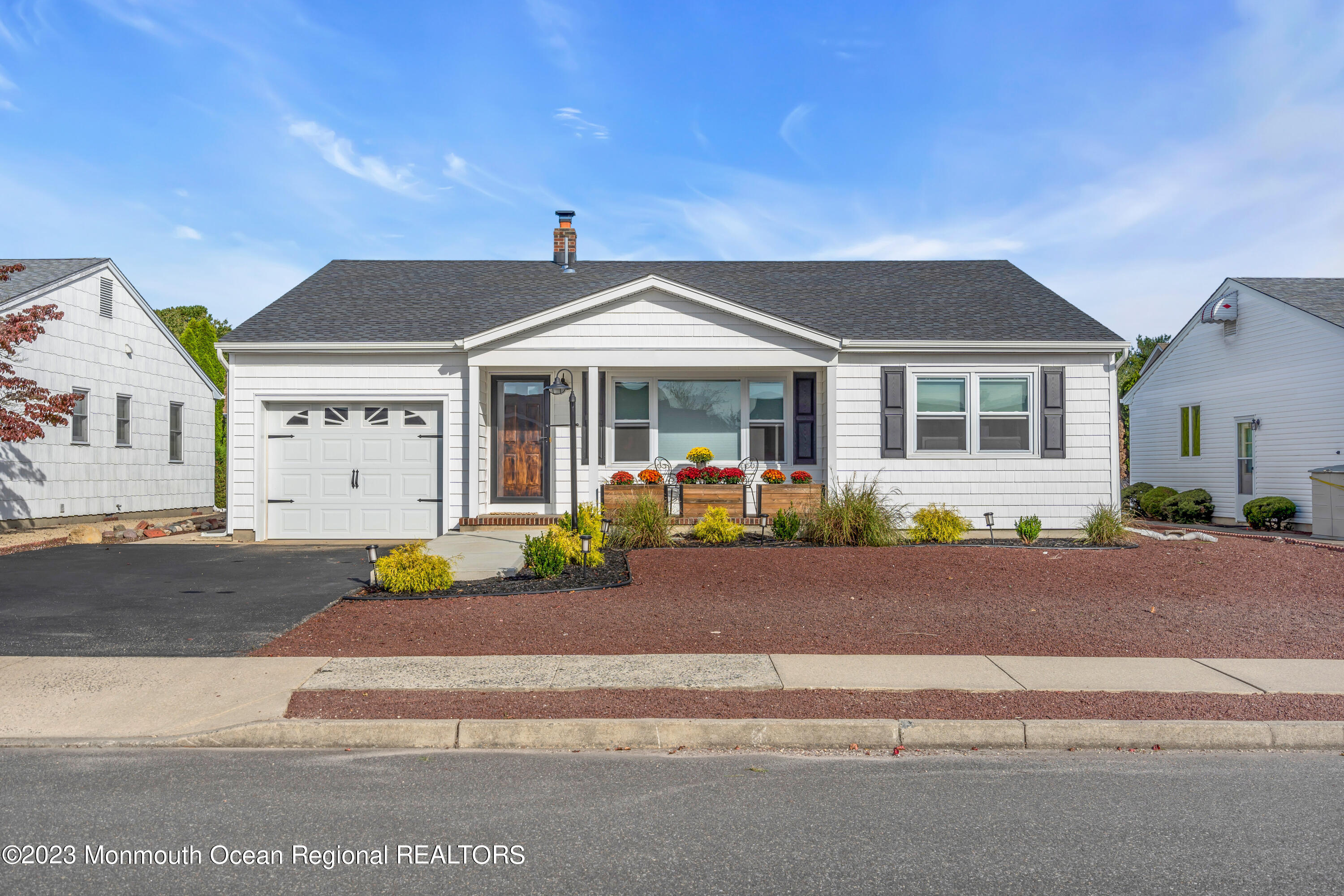 11 Garrett Road Toms River, NJ 08757 - Photo 6 of 61 a front view of a house with a garden and patio