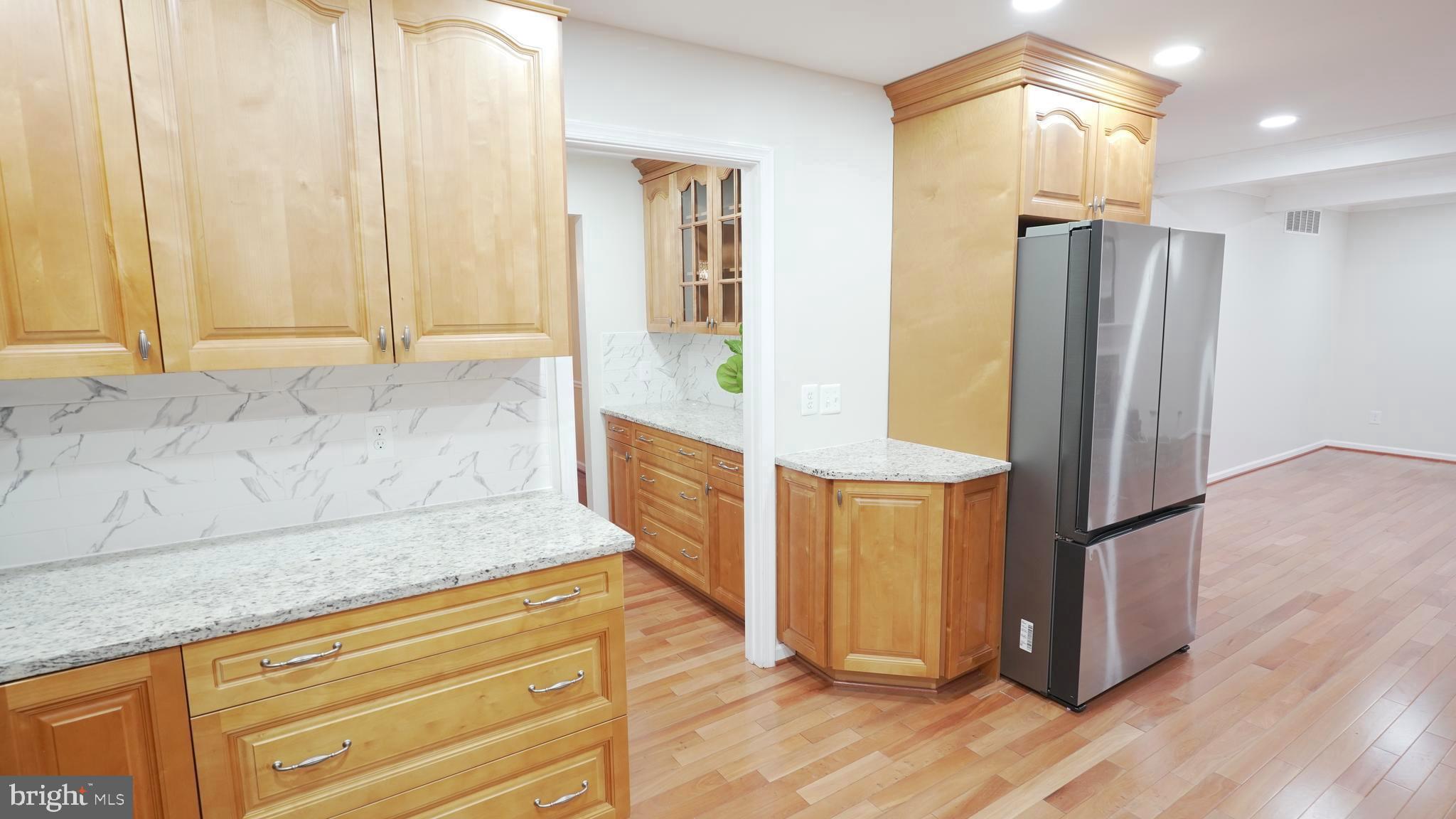 10203 Raleigh Tavern Lane Ellicott City, MD 21042 - Photo 16 of 57 a kitchen with stainless steel appliances granite countertop a refrigerator and a stove top oven