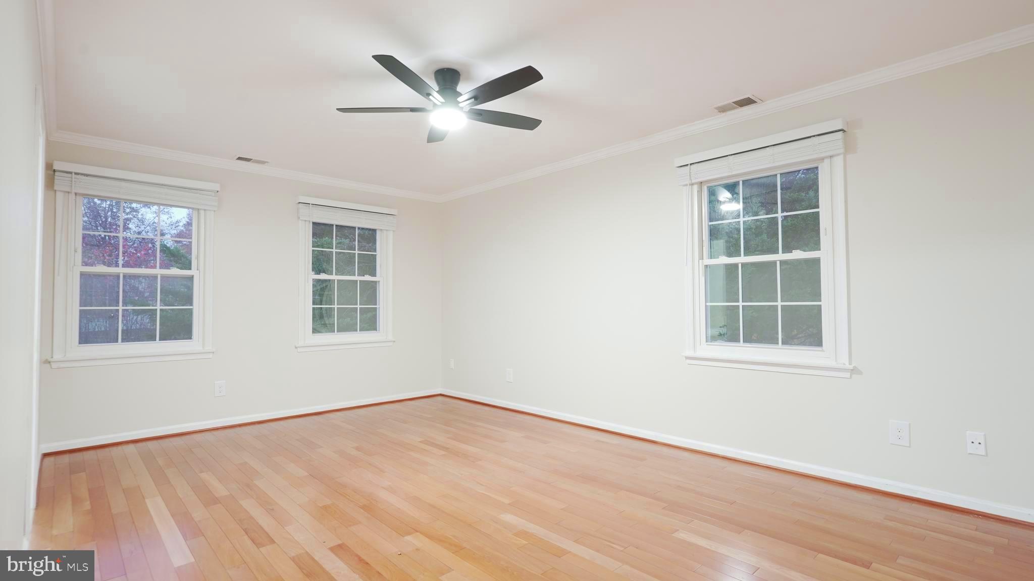 10203 Raleigh Tavern Lane Ellicott City, MD 21042 - Photo 26 of 57 an empty room with wooden floor and windows
