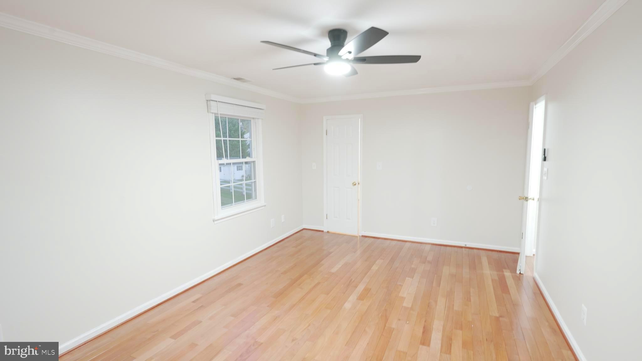 10203 Raleigh Tavern Lane Ellicott City, MD 21042 - Photo 28 of 57 an empty room with a window and a ceiling fan