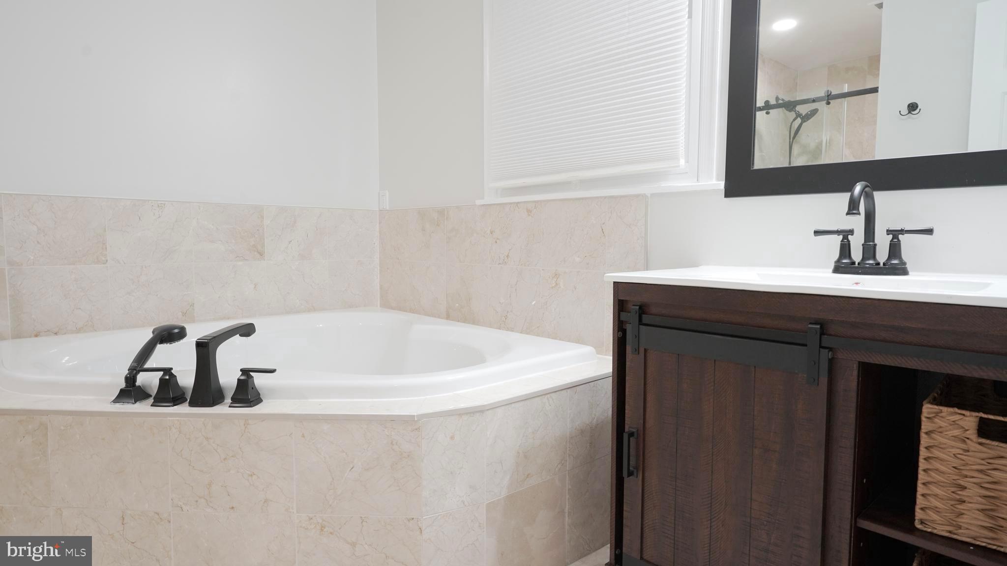10203 Raleigh Tavern Lane Ellicott City, MD 21042 - Photo 33 of 57 a white bath tub sitting in a bathroom