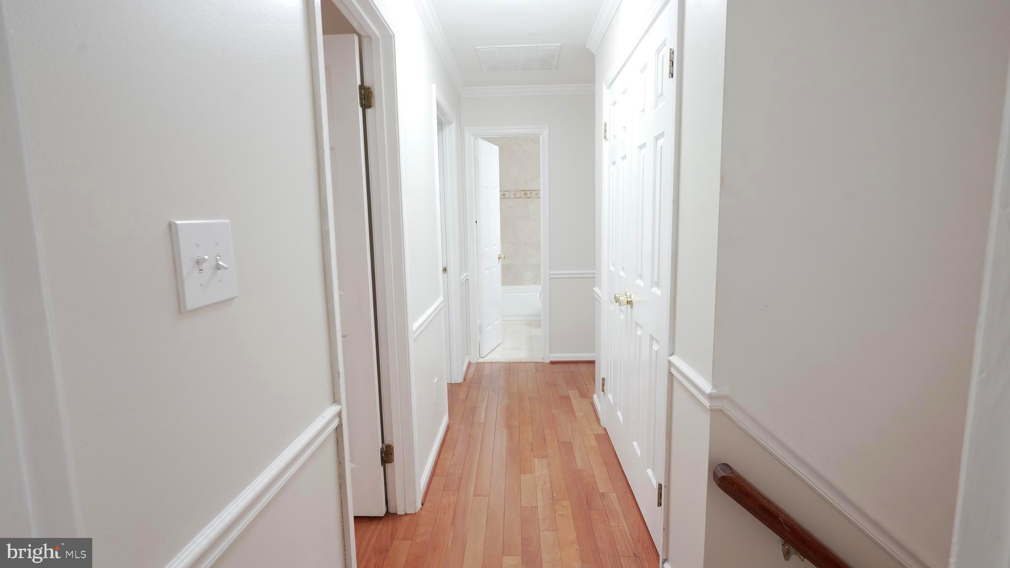 10203 Raleigh Tavern Lane Ellicott City, MD 21042 - Photo 36 of 57 a view of a hallway with wooden floor