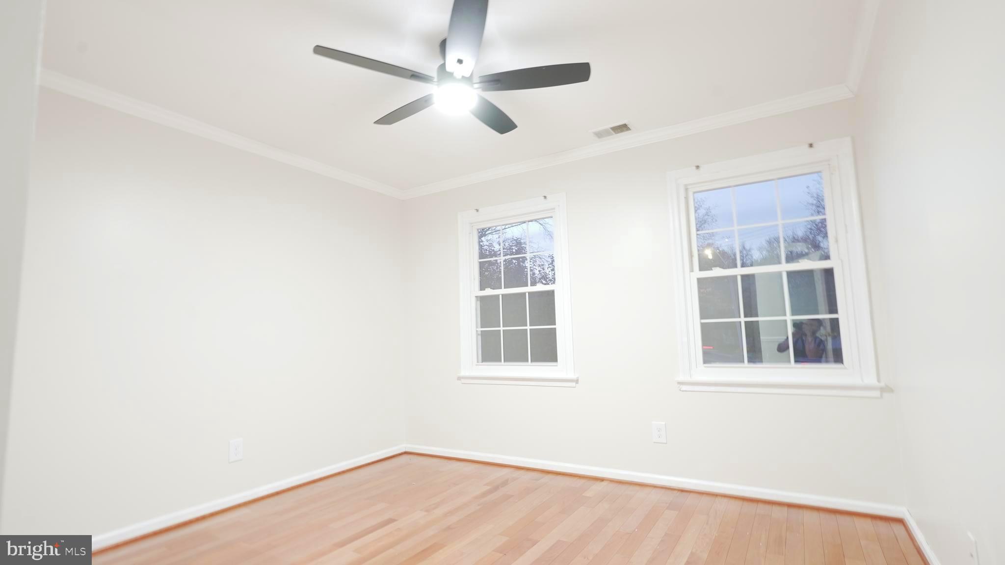 10203 Raleigh Tavern Lane Ellicott City, MD 21042 - Photo 39 of 57 a view of empty room with wooden floor and fan