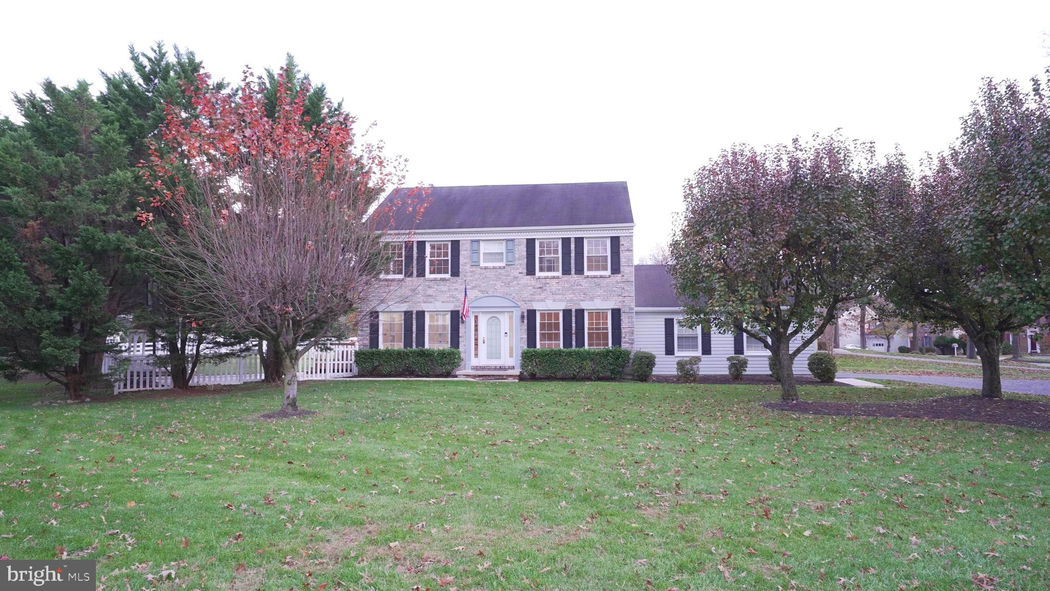 10203 Raleigh Tavern Lane Ellicott City, MD 21042 - Photo 49 of 57 a view of a house with a big yard and large trees