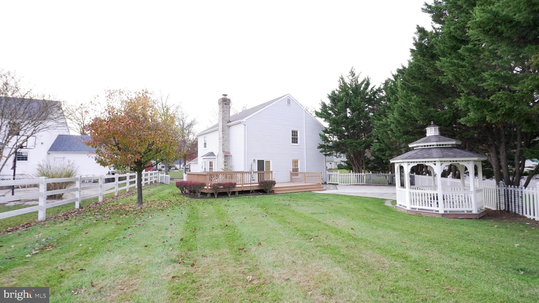 10203 Raleigh Tavern Lane Ellicott City, MD 21042 - Photo 53 of 57 a view of a house with a yard porch and sitting area