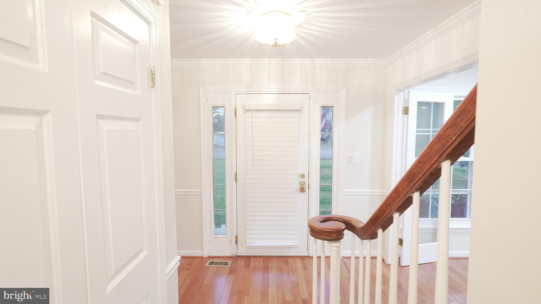 10203 Raleigh Tavern Lane Ellicott City, MD 21042 - Photo 8 of 57 a view of entryway with wooden floor and stairs