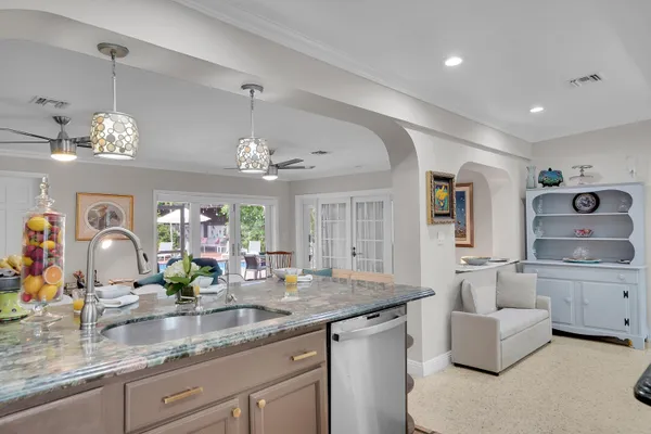 a view of living room kitchen with granite countertop living room and couch