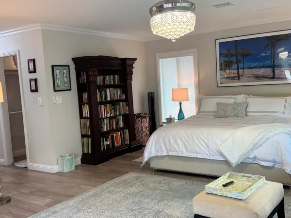 a bedroom with a bed and a book shelf