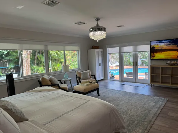 a bedroom with a large bed and a large window