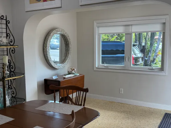 a dining room with furniture and a window