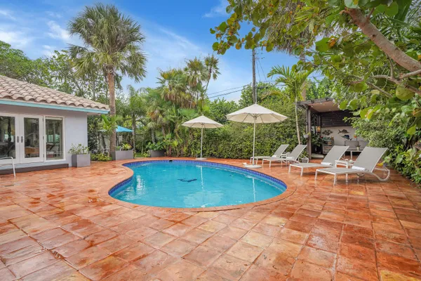 a swimming pool with outdoor seating yard and patio