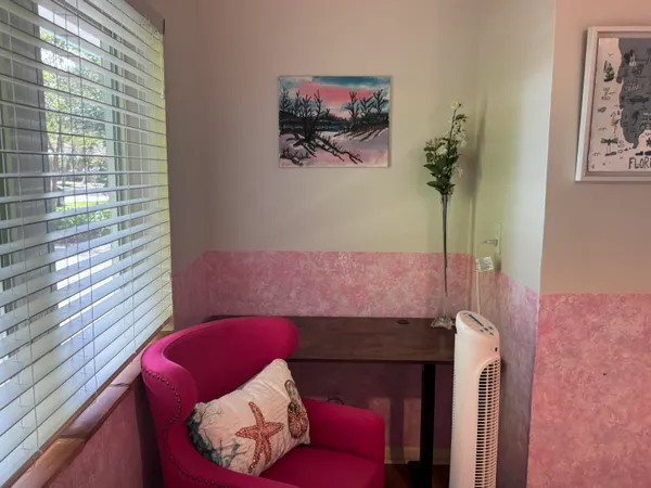 a living room with furniture and a potted plant