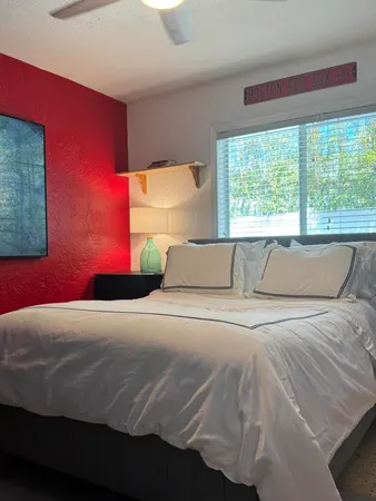 a bedroom with a bed and a window