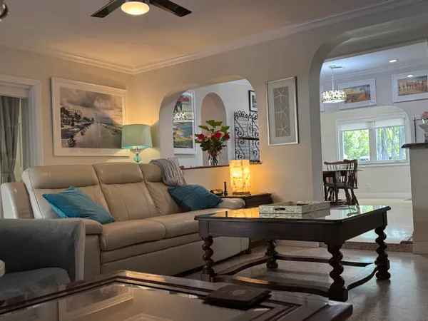 a living room with furniture and wooden floor