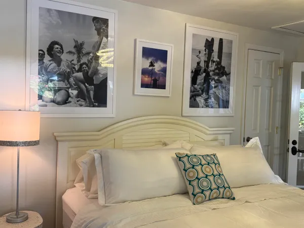 a bedroom with a bed and a painting on the wall