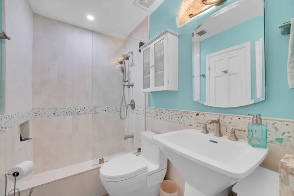 a bathroom with a sink toilet tub and shower