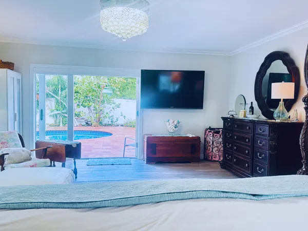 a living room with furniture a large window and a flat screen tv