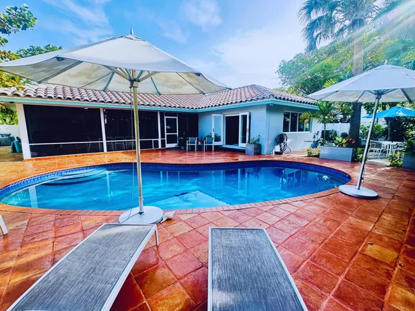 a view of a swimming pool with a lounge chairs