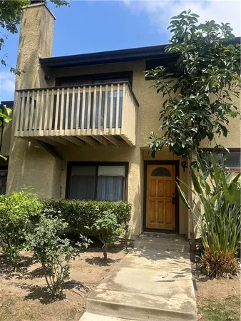 a view of a house with a small yard and plants