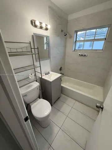 a bathroom with a sink a toilet and bathtub