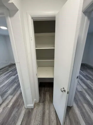 an empty room with wooden floor