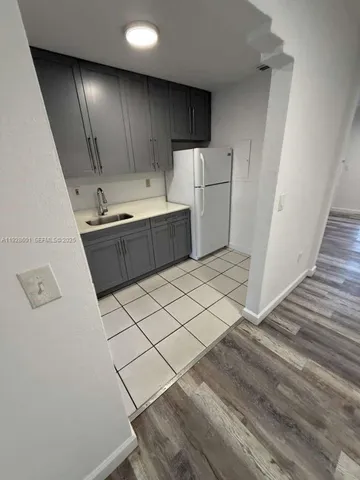a kitchen with granite countertop cabinets and white appliances