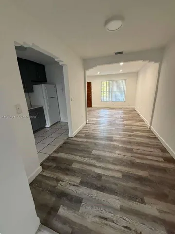 wooden floor in an empty room with a fireplace