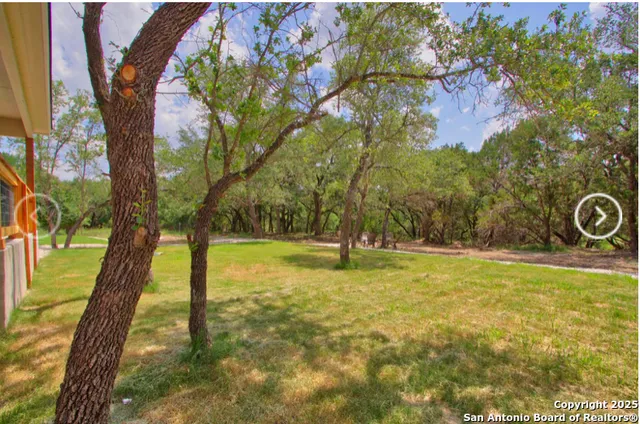 a view of a backyard with sitting area