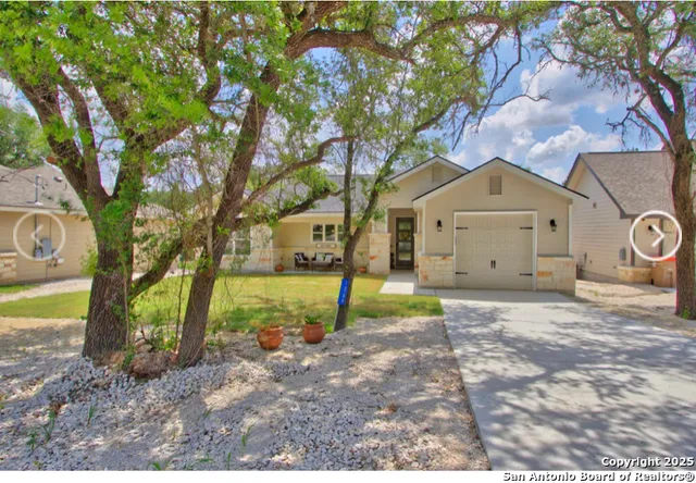 a living room with patio furniture and a large window