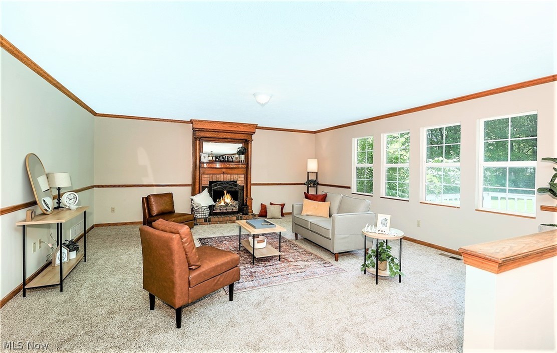 3432 Shellhart Road Barberton, OH 44203 - Photo 9 of 33 *FAMILY RM W/NEW CARPET, CHAIR RAIL AND CROWN MOLDING, BRICK FIREPLACE W/PILLAR SURROUND, 4 WINDOWS FOR NATURAL LIGHT ~