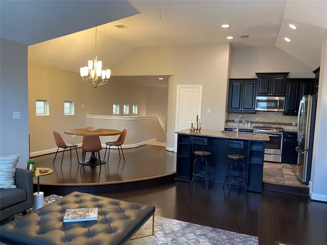 a living room with furniture and a dining table