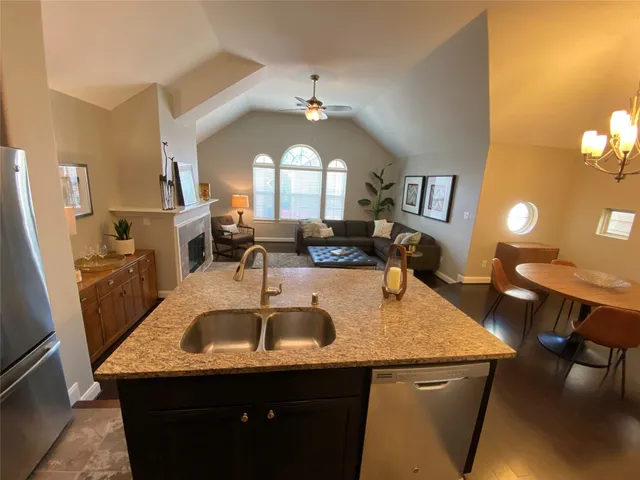 a kitchen with a sink a counter space and dining table