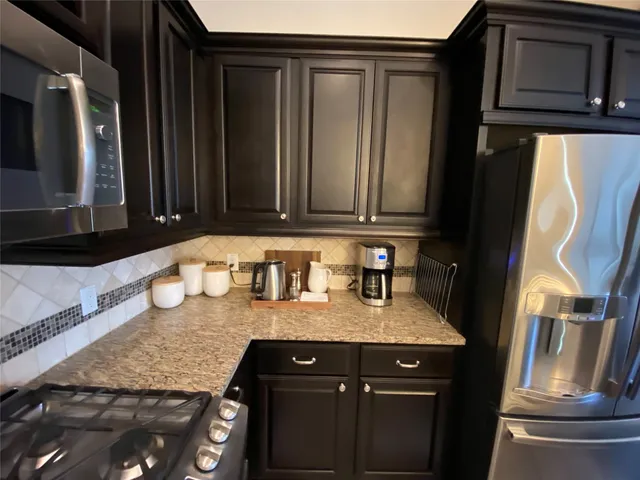 a kitchen with granite countertop a sink and cabinets