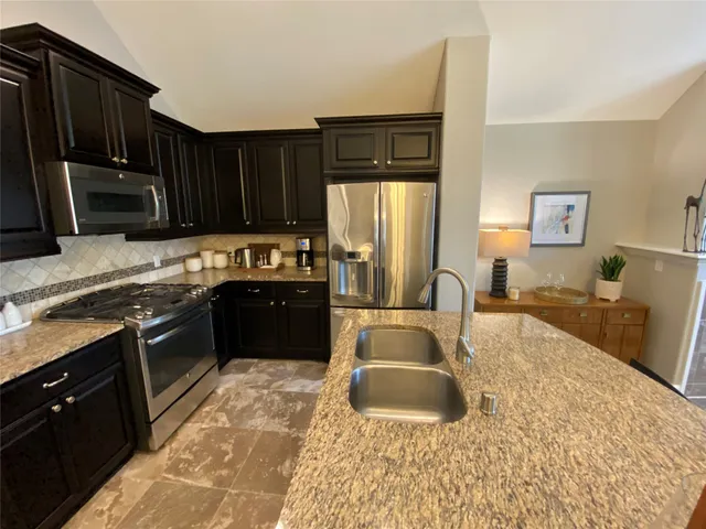 a kitchen with a sink stove and refrigerator