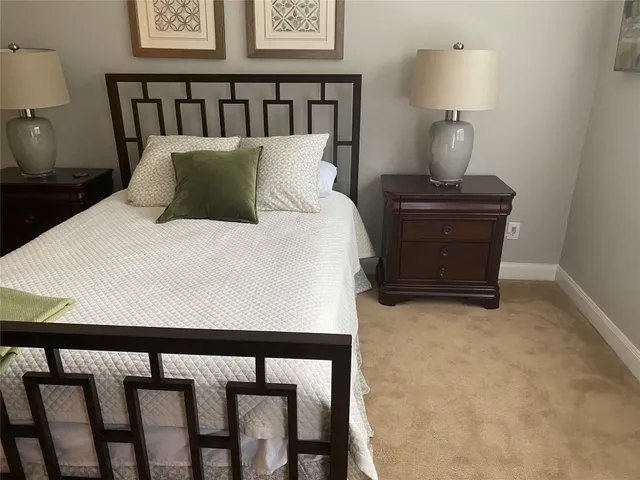 a bedroom with a bed and lamp on table