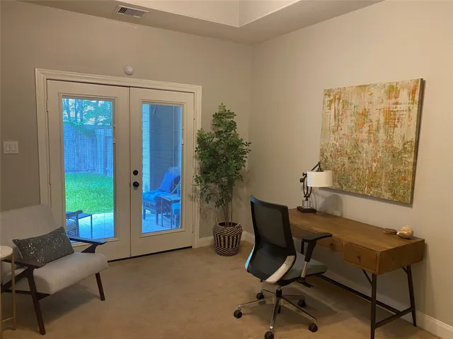 a view of a livingroom with workspace and a couch