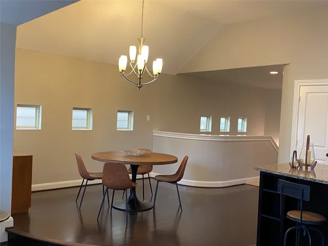 a view of a dining room with furniture and chandelier