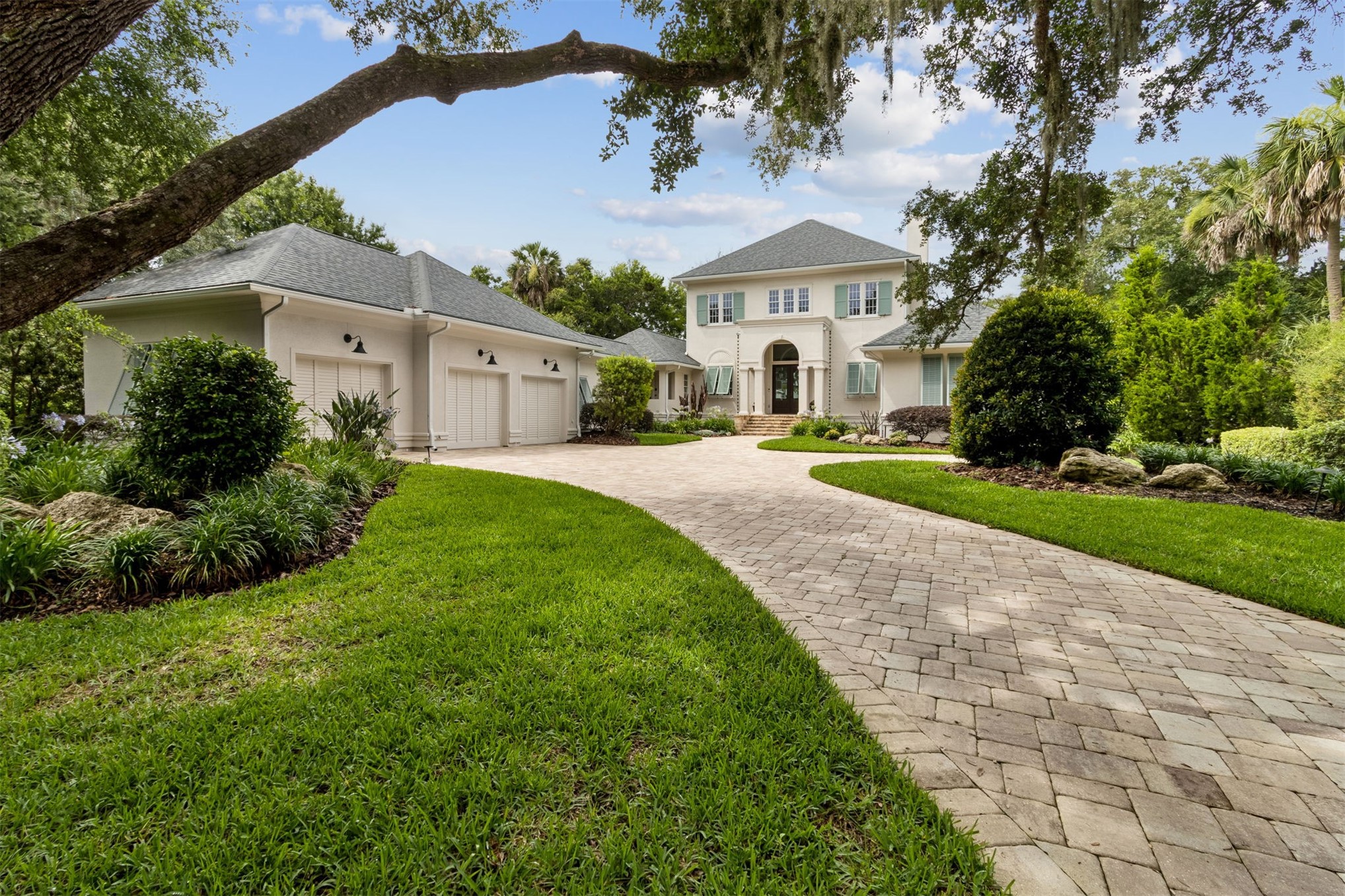 12 Marsh Point Road Fernandina Beach, FL 32034 - Photo 1 of 79 a front view of a house with a yard and garage