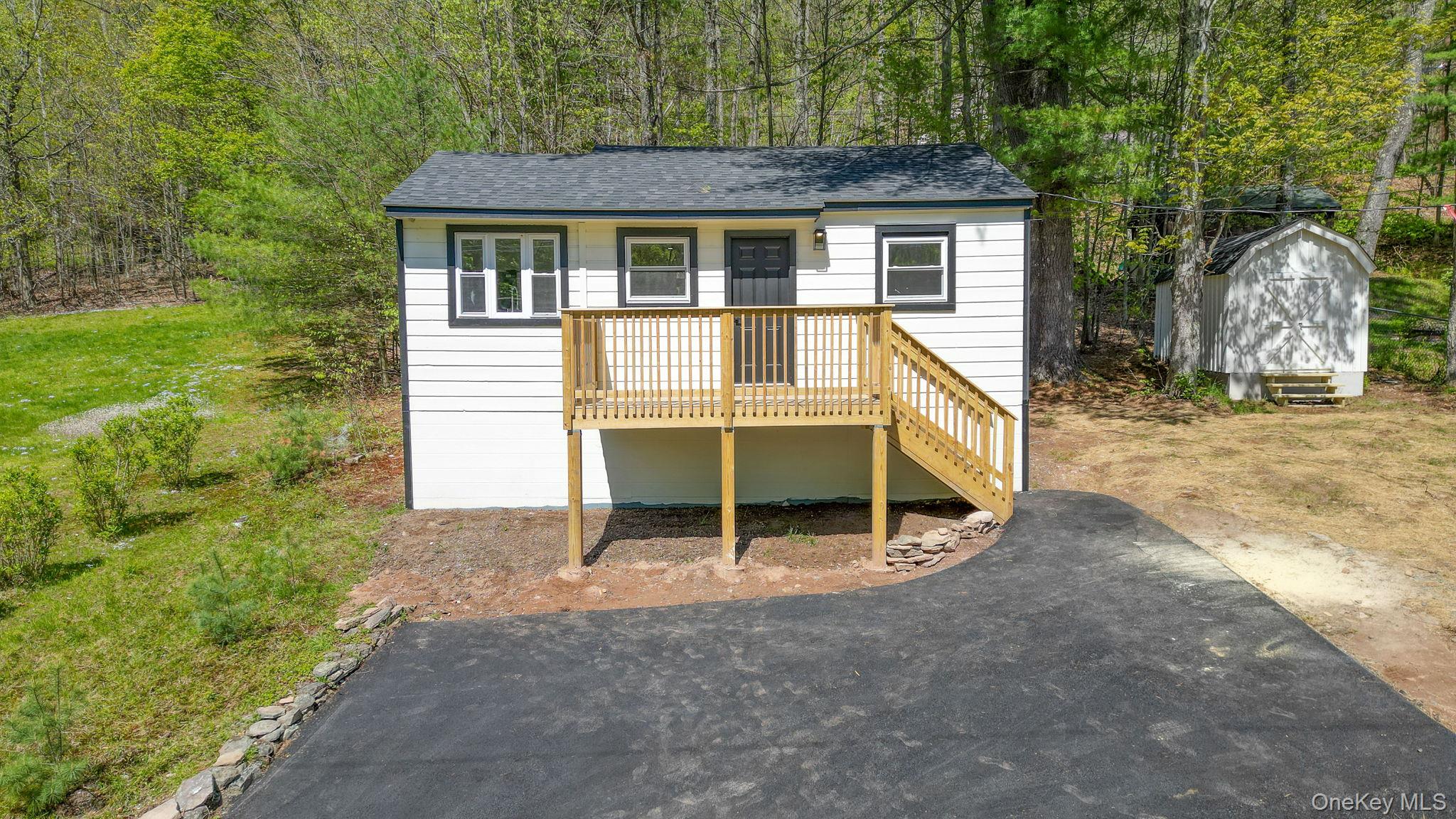 25 Overlook Road Woodbourne, NY 12788 - Photo 19 of 22 front view of house with a yard and wooden fence