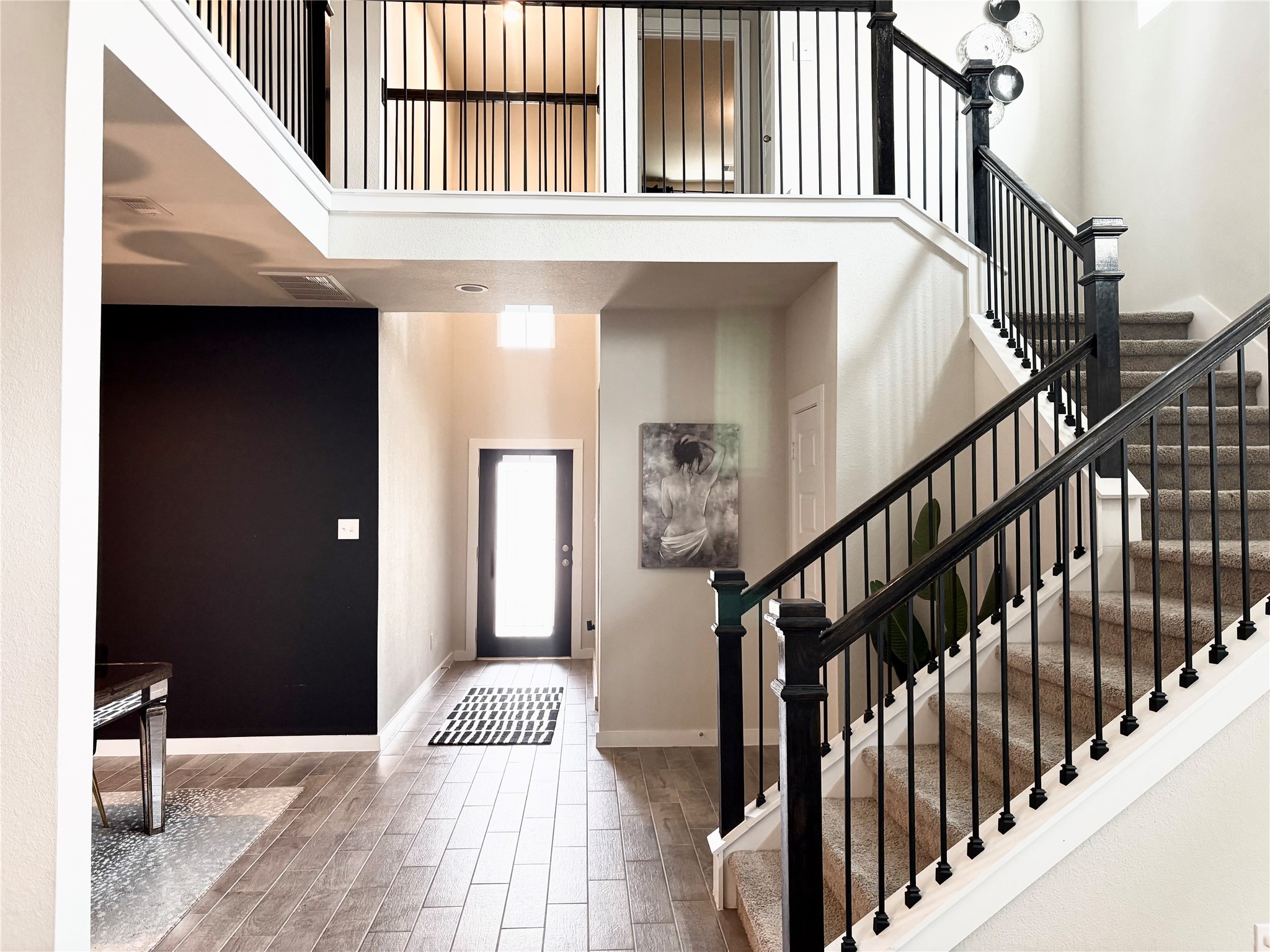 2142 Reed Cave Lane Spring, TX 77386 - Photo 9 of 15 a view of staircase with lots of frames on wall and wooden floor