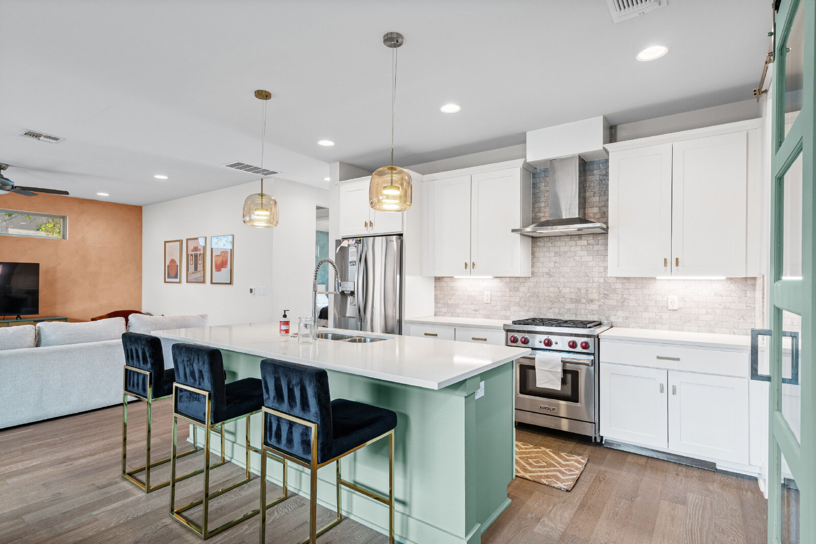 2906 Webberville Road, Unit 1 Austin, TX 78702 - Photo 6 of 23 a kitchen with stainless steel appliances granite countertop a sink a stove a refrigerator and a dining table with wooden floor