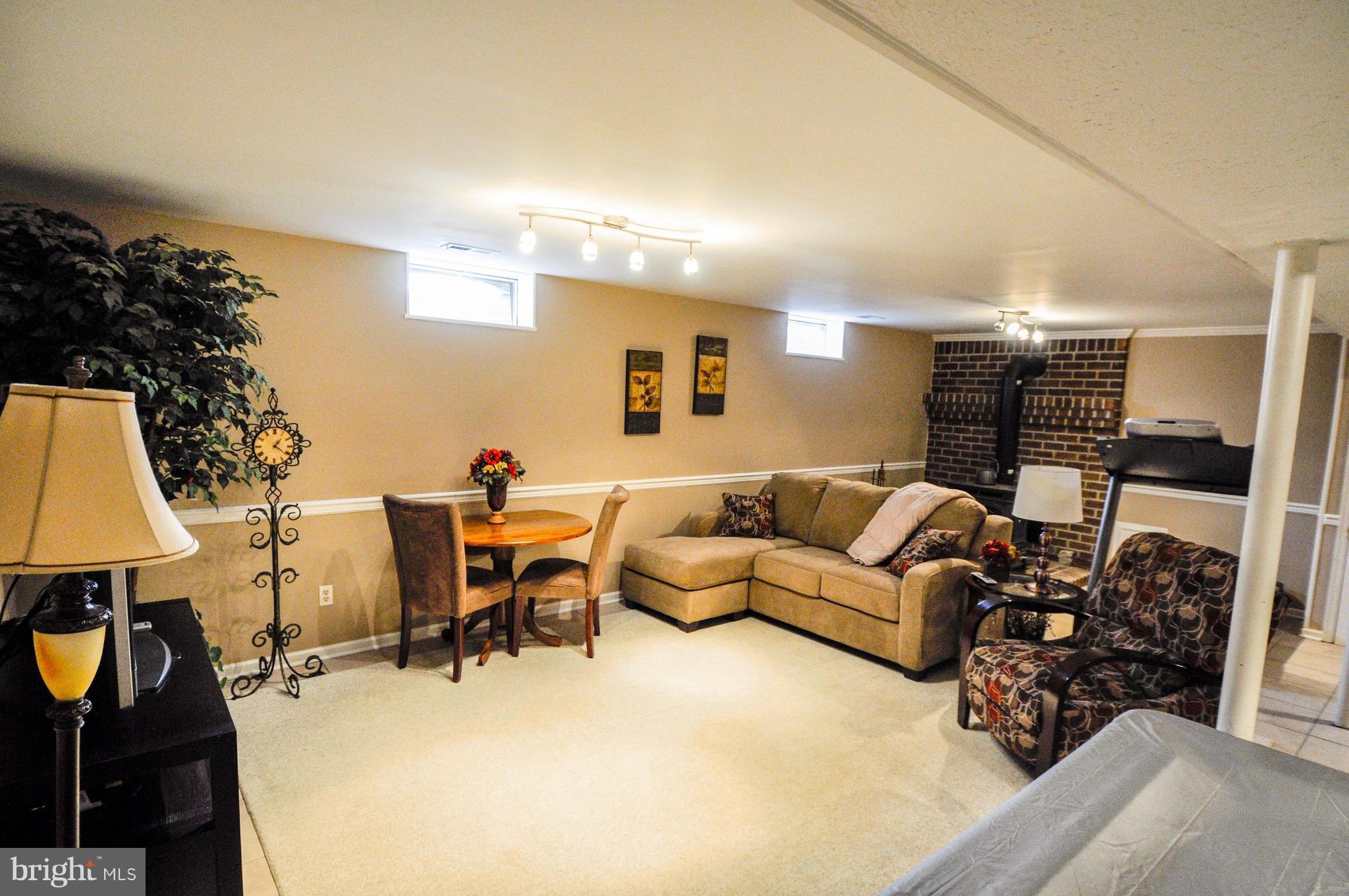 5502 Woodlyn Road Frederick, MD 21703 - Photo 22 of 30 a living room with furniture a table and chairs