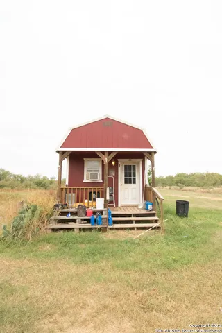 a view of a house with a yard and sitting area